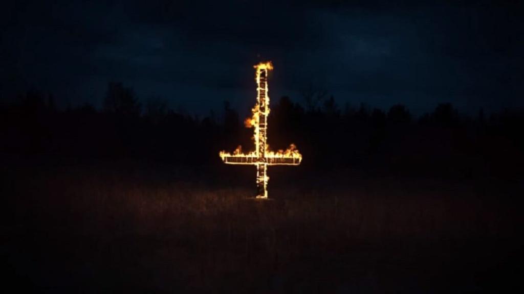 Inverted cross lit on fire in Outlast 2.