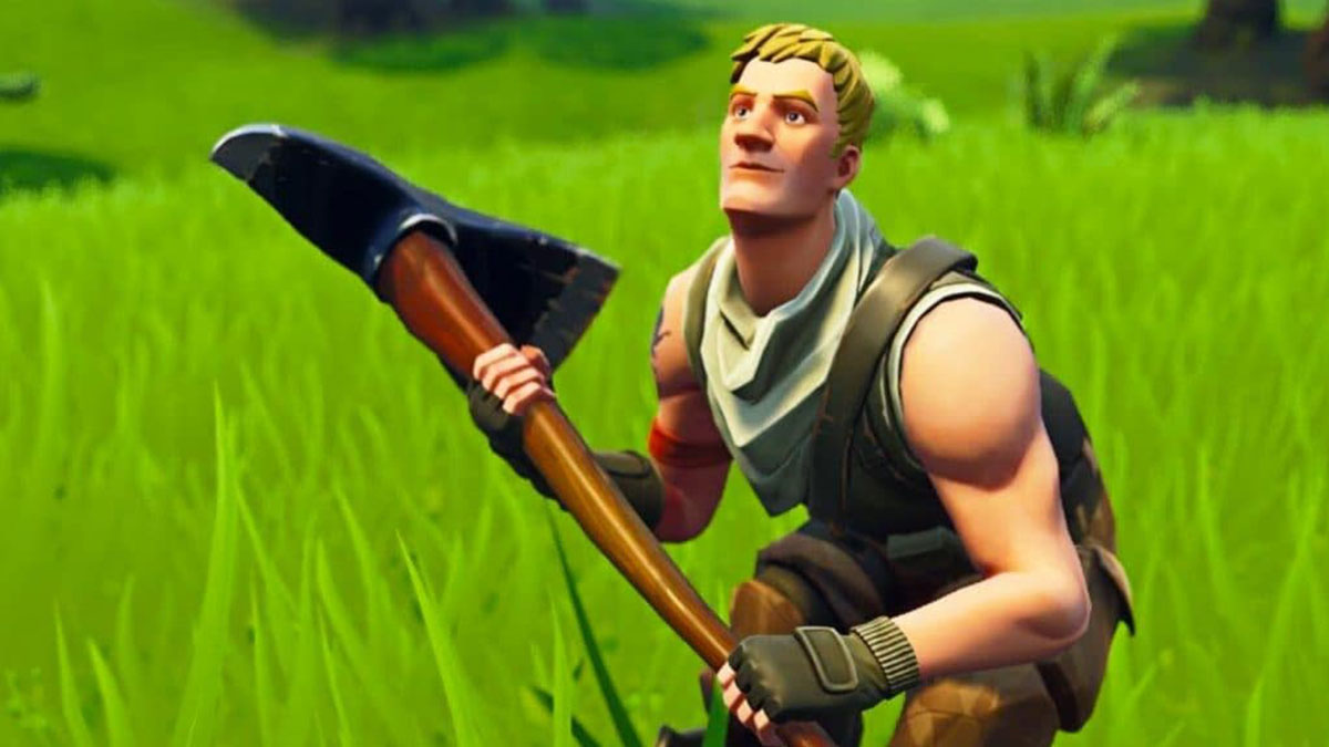 Jonesy crouching in the grass holding Fortnite's default pickaxe.