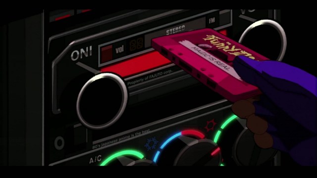 Mullet MadJack slotting a pink audio cassette that says "Magic is Real"