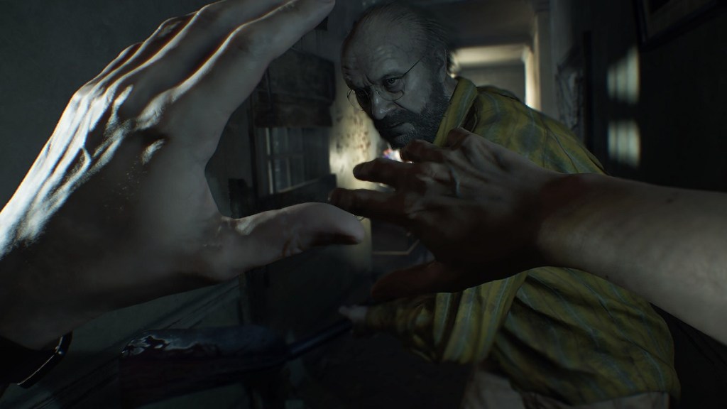 Resident Evil 7: the players holds their hands up in defense as Jack Baker goes in to attack.