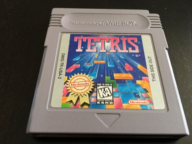 A gray Tetris cartridge for the Game Boy on a dark background.