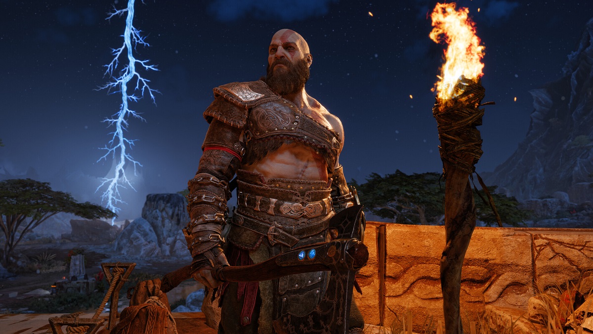 God of War Ragnarok: Krtos looks mean next to a lit torch, as lightning strikes behind him.