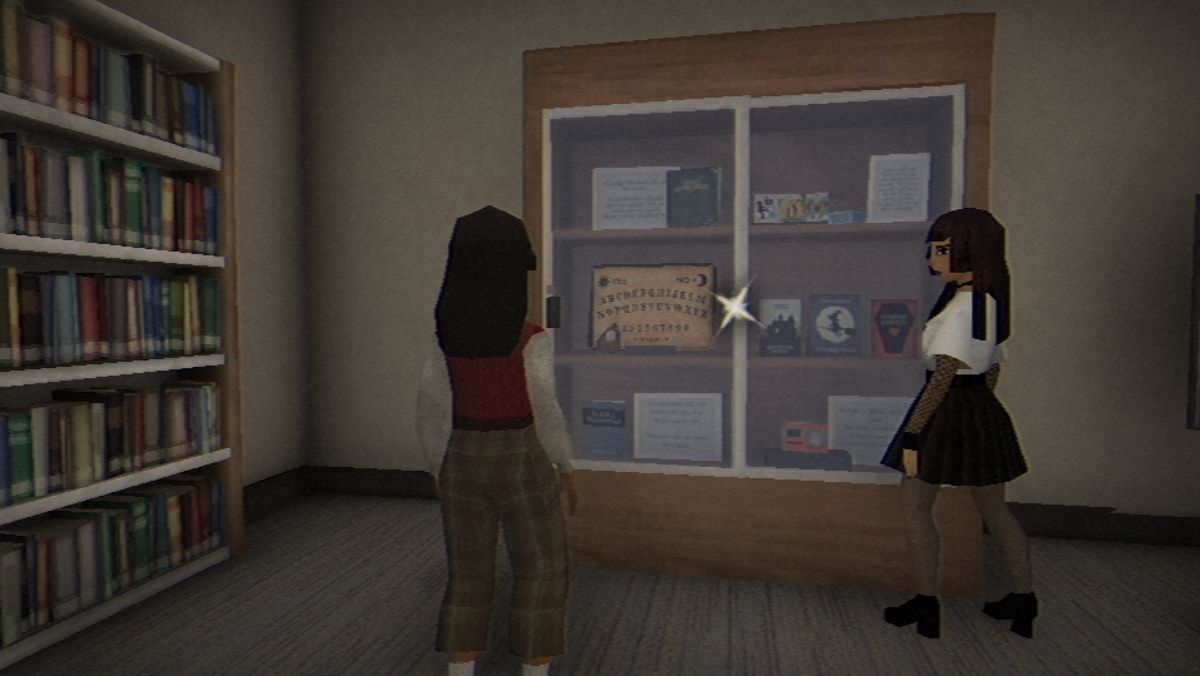 Vivian and Amy standing near the library's display case.