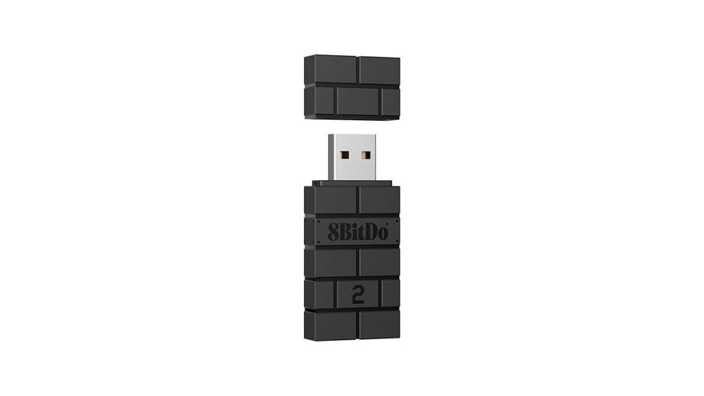 the 8BitDo wireless adapter, a usb pendrive shaped after the brick layout from Super Mario games.