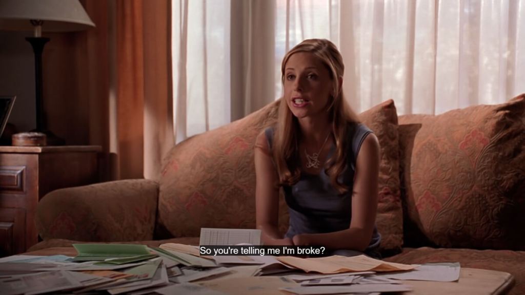 Buffy the Vampire Slayer screenshot of Buffy next to a pile of bills.