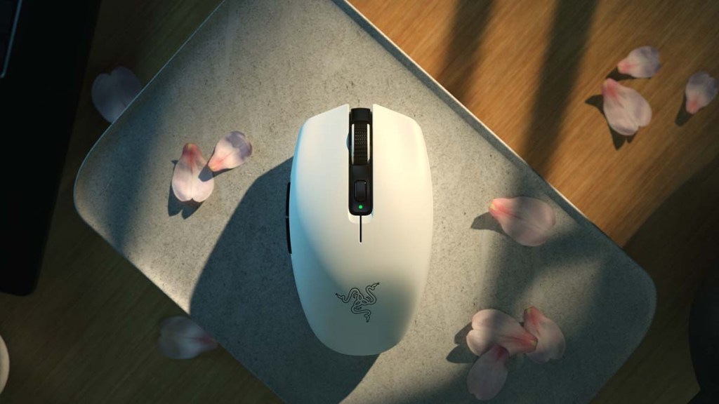 Razer Orochi's white version on a table surrounded by pink petals.