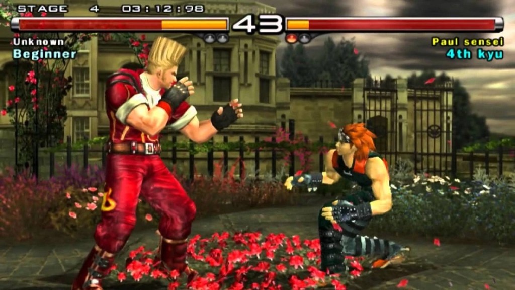 Tekken 5: tall-haired Paul Phoenix squares off against Hwoarang, who's crouching down.
