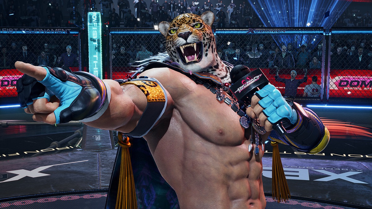 Tekken 8: King stands in a wrestling ring and holds a microphone while pointing off-screen.