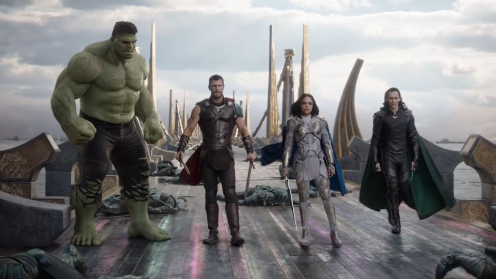 Thor, Hulk, Loki, and Valkyrie standing on the rainbow bridge in Asgard in Marvel's Thor: Ragnarok.