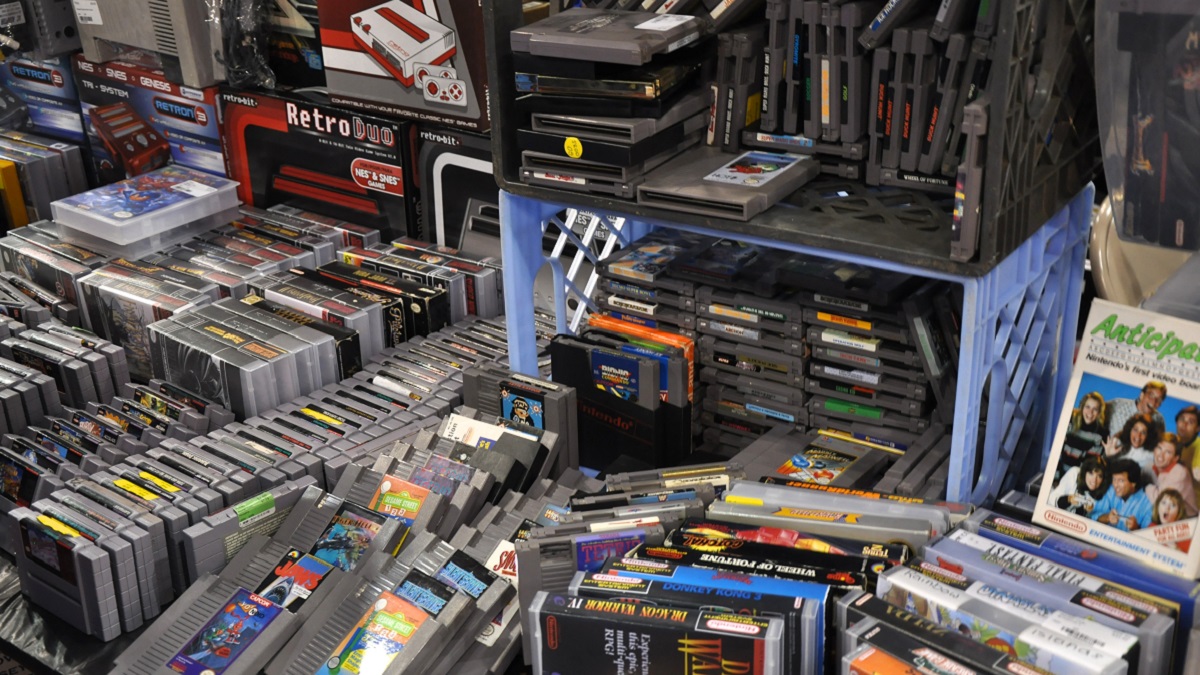 A photo showing stacks of old gaming cartridges and boxes.