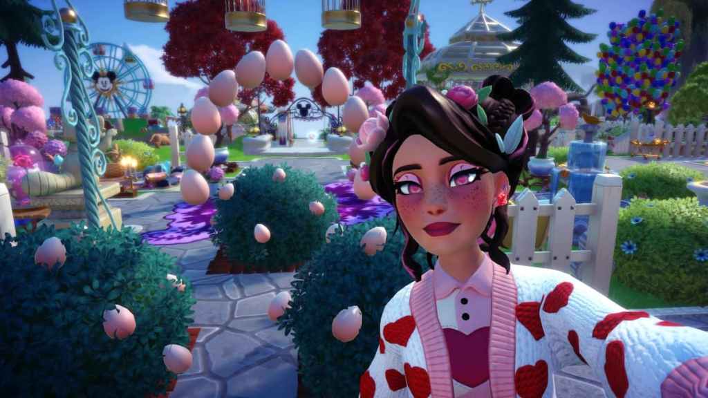 A player with a brown updo wearing a white and red heart cardigan taking a picture with some egg bushes in Disney Dreamlight Valley. 