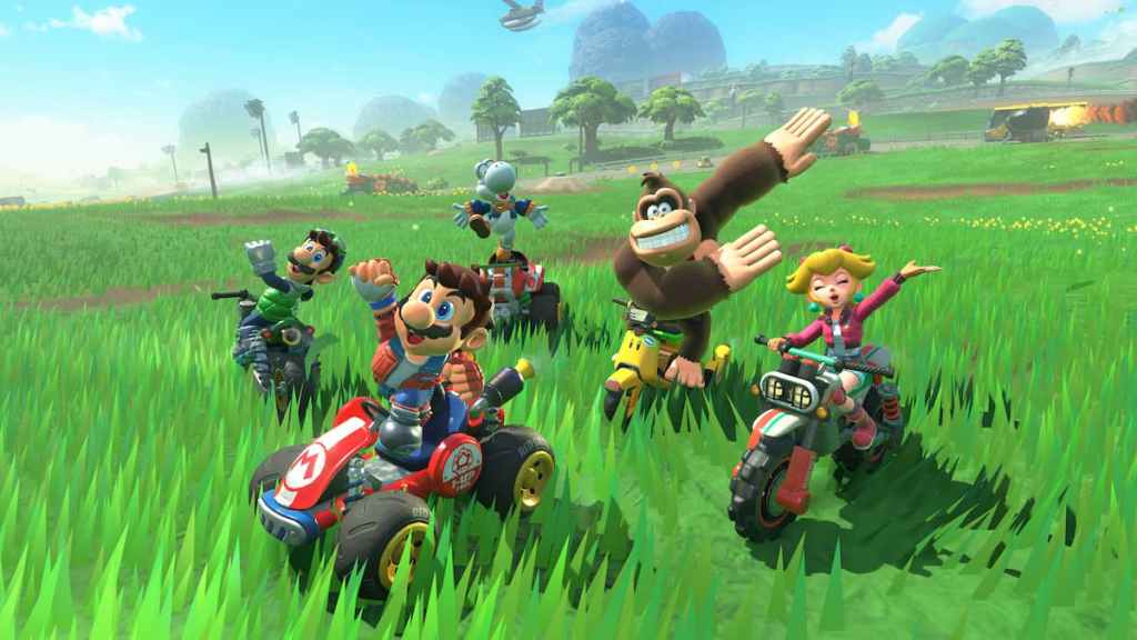 Mario, Luigi, Yoshi, Peach, and Donkey Kong driving on bright green grass in Mario Kart World. 