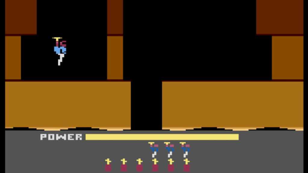 A man in a helmet drops down into an arena with a helicopter on his backpack in H.E.R.O. 