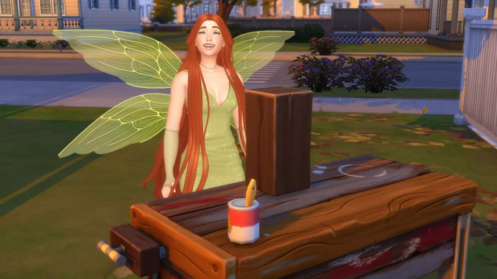A Sim dressed as a fairy in a green dress with green wings and long orange hair crafting a wooden sculpture in the sims 4
