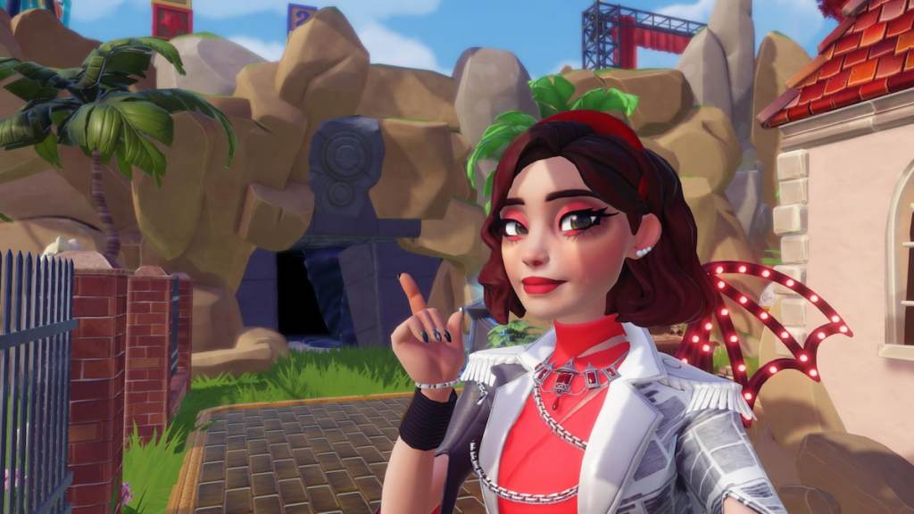 A player with a red and white outfit, short brown hair, red headband, and red rings pointing at a grey cave entrance in the wall in Disney Dreamlight Valley