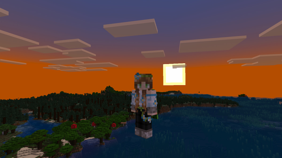 A player floating in the sky with a vibrant sunset going down over the forest and ocean behind them in Minecraft
