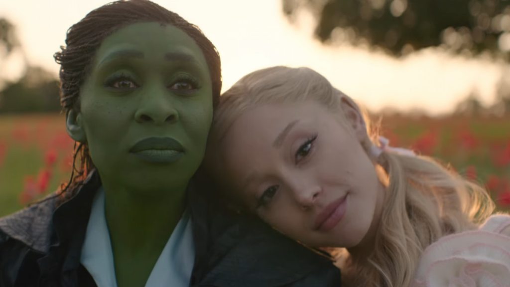 Glinda leaning on Elphaba's shoulder in Wicked: For Good
