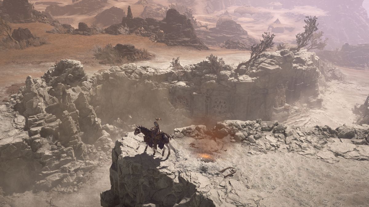 A screenshot of Diablo IV, featuring a horseman on a cliff.