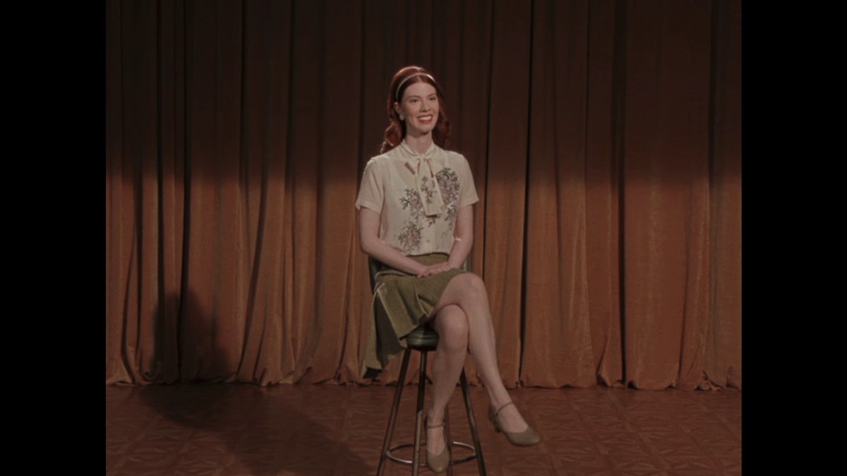 Marissa Marcel sitting on the main menu stool