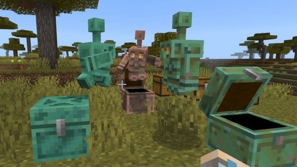 One green copper golem, one copper colored copper golem, and one green and copper colored copper golem standing on three chests in minecraft