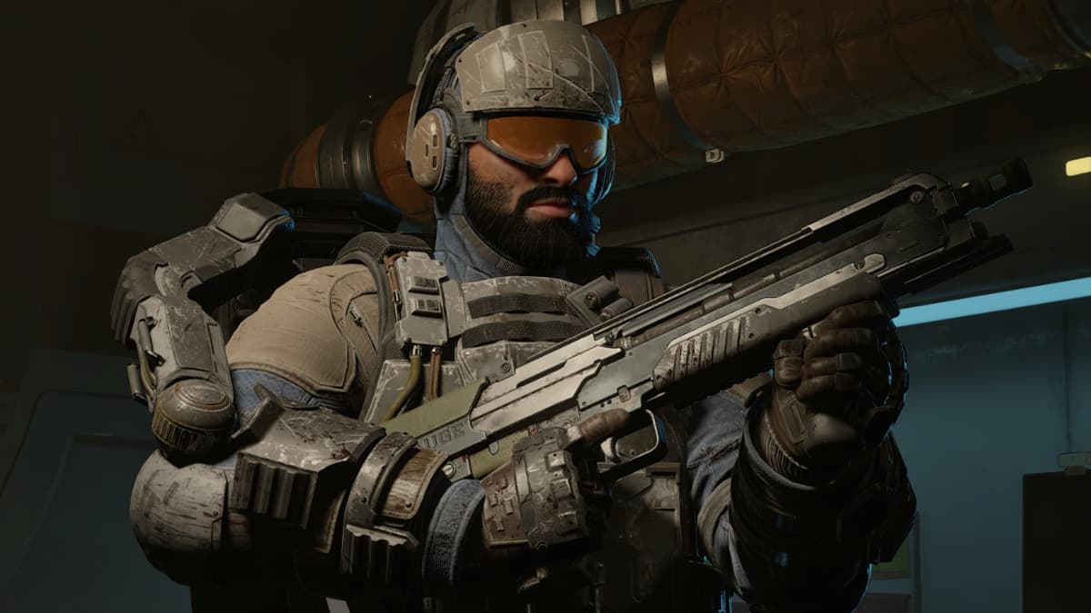 A man wearing military clothes, a helmet and visor while carrying a shotgun in his hands in Killing Floor 3.