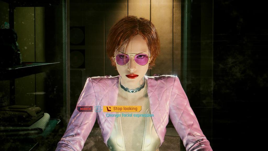 A red-haired woman wearing a pink jacket and pink eyeglasses looking at the mirror in Cyberpunk 2077. 