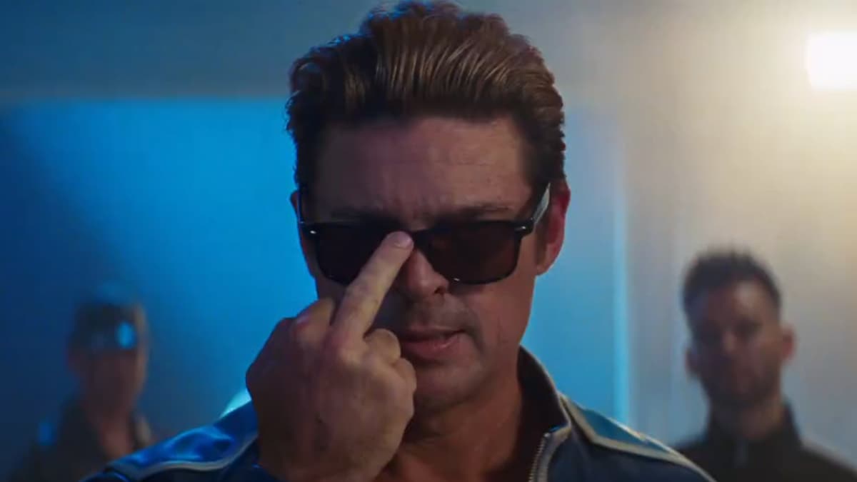 Karl Urban as Johnny Cage putting glasses on with his middle finger.
