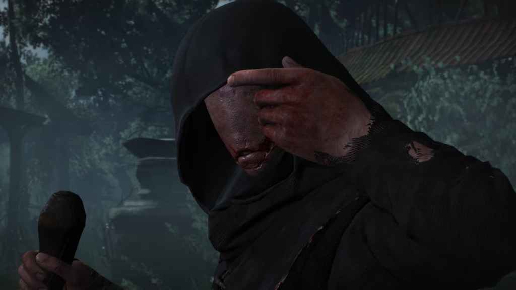 A faceless man with a hood on watching at the camera amid a graveyard in The Witcher 3: Wild Hunt. 