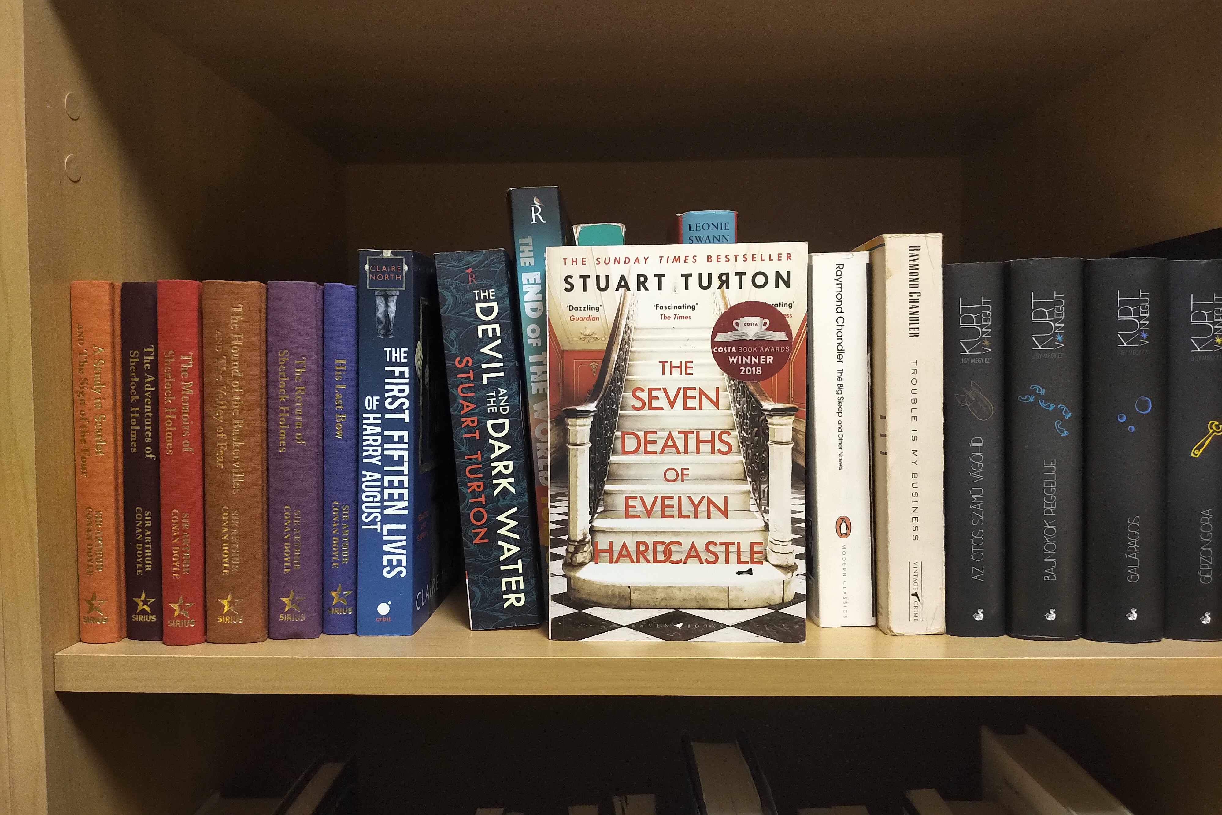 A bookshelf displaying The Seven Deaths of Evelyn Hardcastle