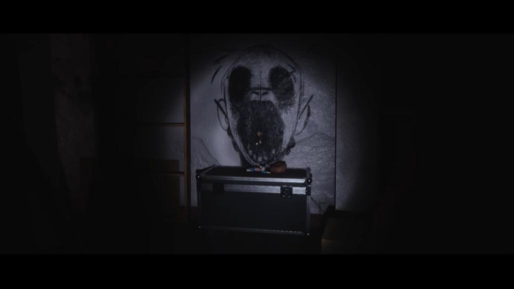 Isaac's deflated ball near wall drawing of a monkey with its mouth wide open