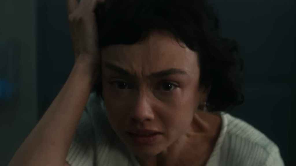 Wendy from Alien: Earth holding a hand on her head in anguish. 