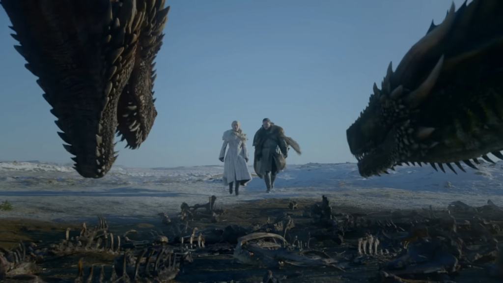 Dany and Jon walking towards two dragons in game of thrones
