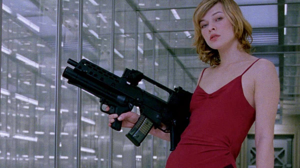 Milla Jovovich portraying Alice in Resident Evil 2002, wearing a red dress and holding a gun in her hand.