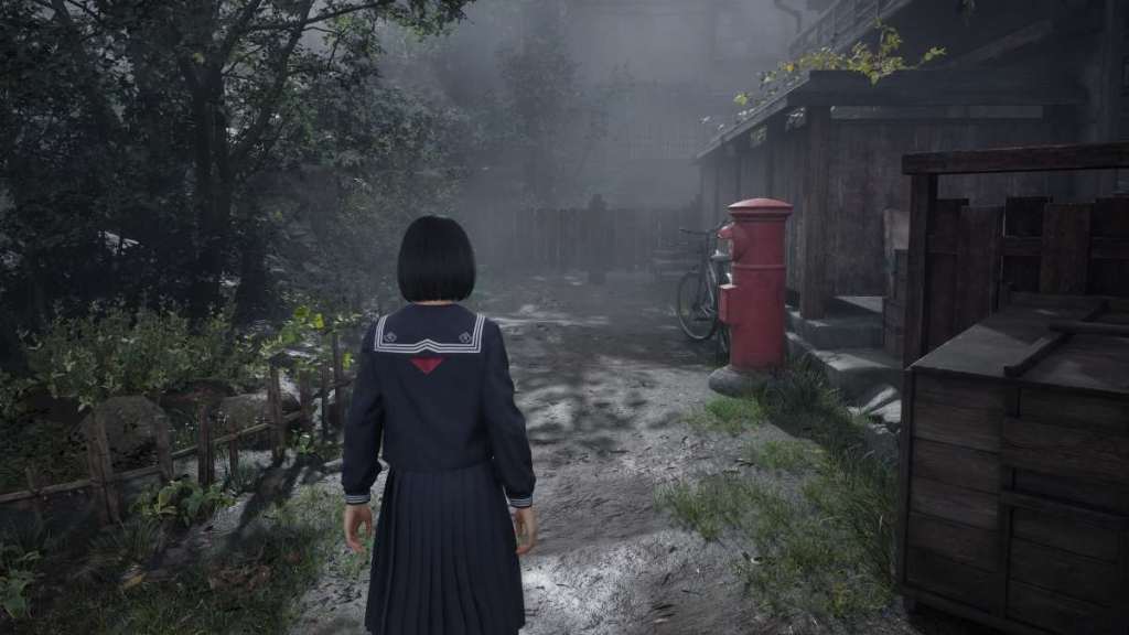 Looking at a red postal box outside a house, parallel to the first shrine