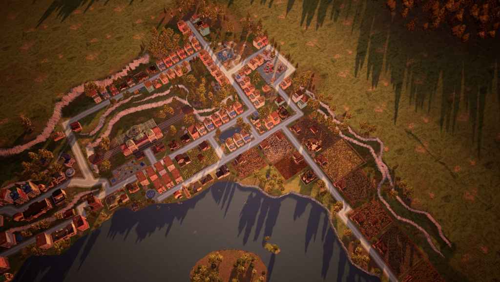 A screenshot from Town to City shows readers a decently sized town full of buildings and farms next to a giant lake.