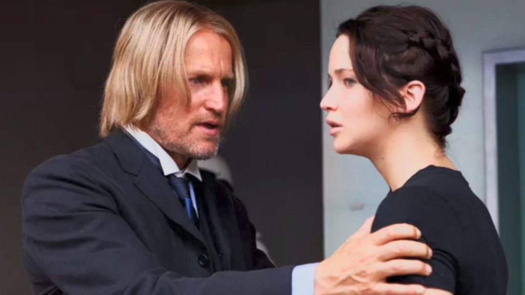 Haymitch talking to katniss with his hand on her shoulder in the hunger games