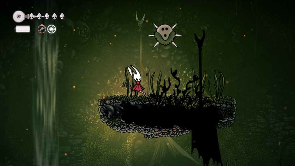 Hornet standing beneath a Hoker in a mossy cave area in Hollow Knight Silksong. 