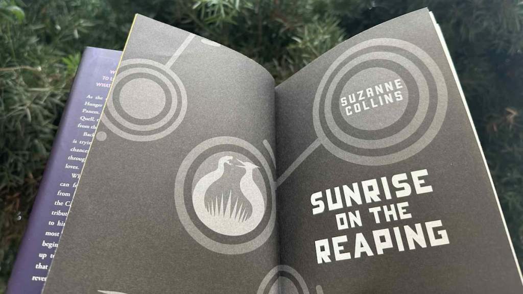 Holding open sunrise on the reaping book in front of tree