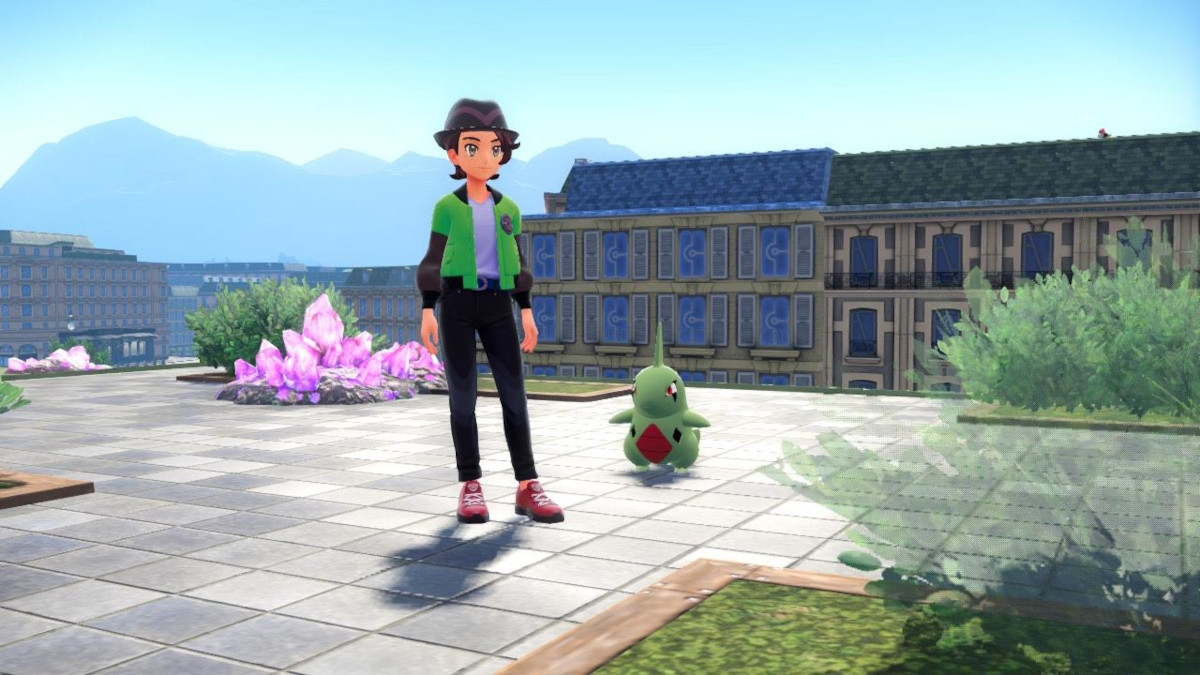 A trainer standing with Larvitar in Pokemon Legends: ZA.