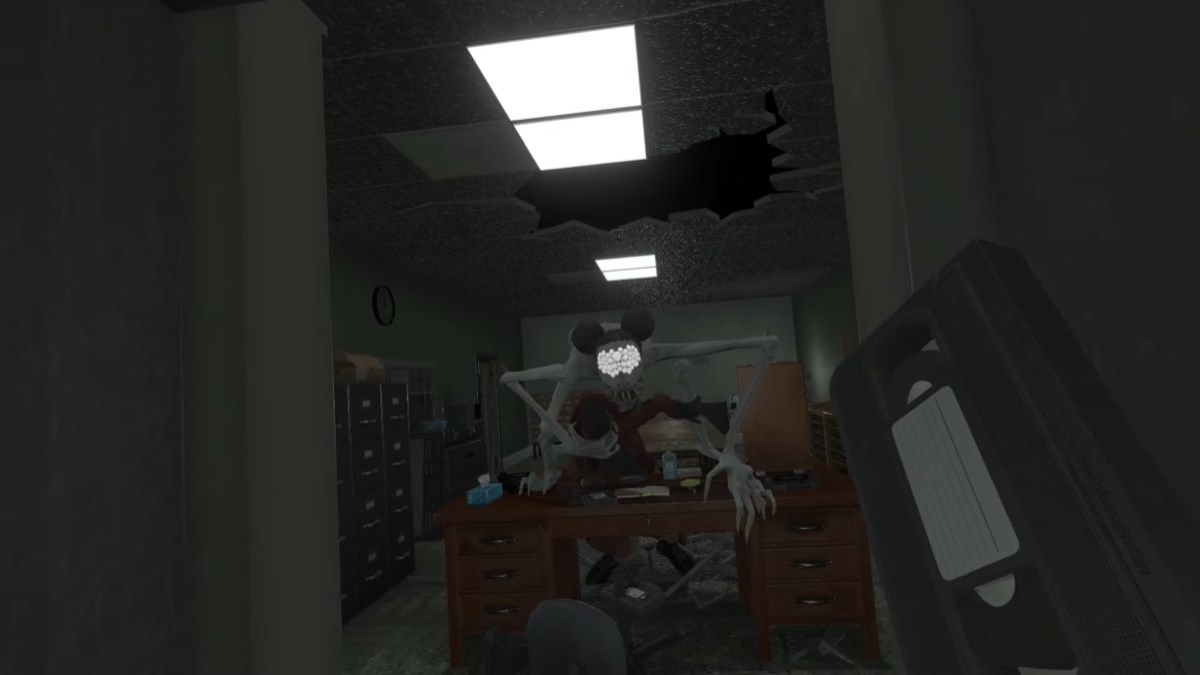 Colton Anomaly standing over Joanne after pinning on top of Kate's desk