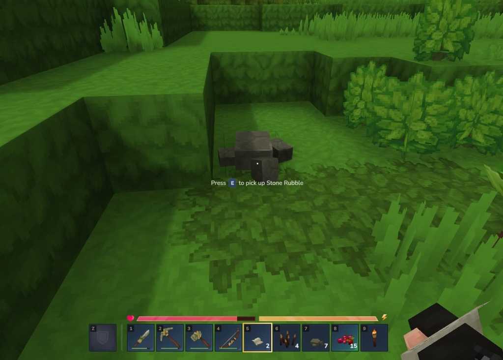 A screenshot from Hytale showing pixelated grass. On top of the green grass is blocky grey stone